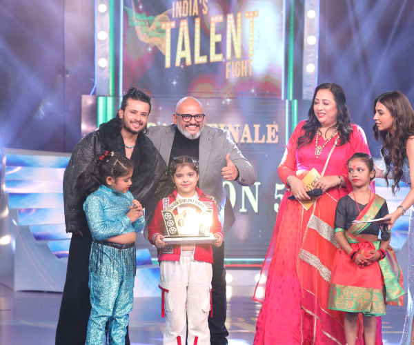 Celebrity judge offering expert artistic feedback and mentoring to contestant on India's Talent Fight