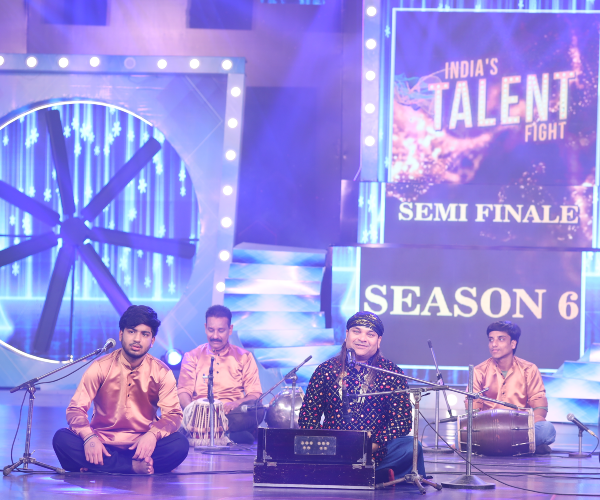 Singer performing live classical and playback melody with microphone on India's Talent Fight national stage