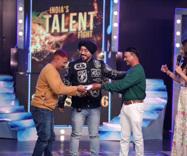 Contestant delivering high-energy folk rock singing performance on India's Talent Fight