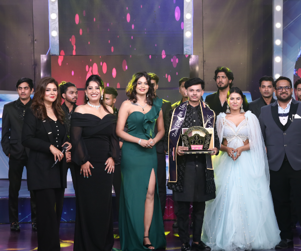 Concert beam lights sweeping across India's Talent Fight performance stage